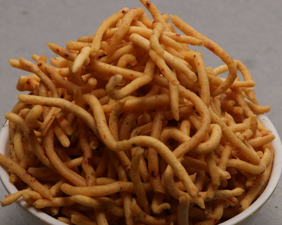 A bowl of Kovilpatti Kara Sevu, which are crispy sev noodles with fiery red chili flakes.