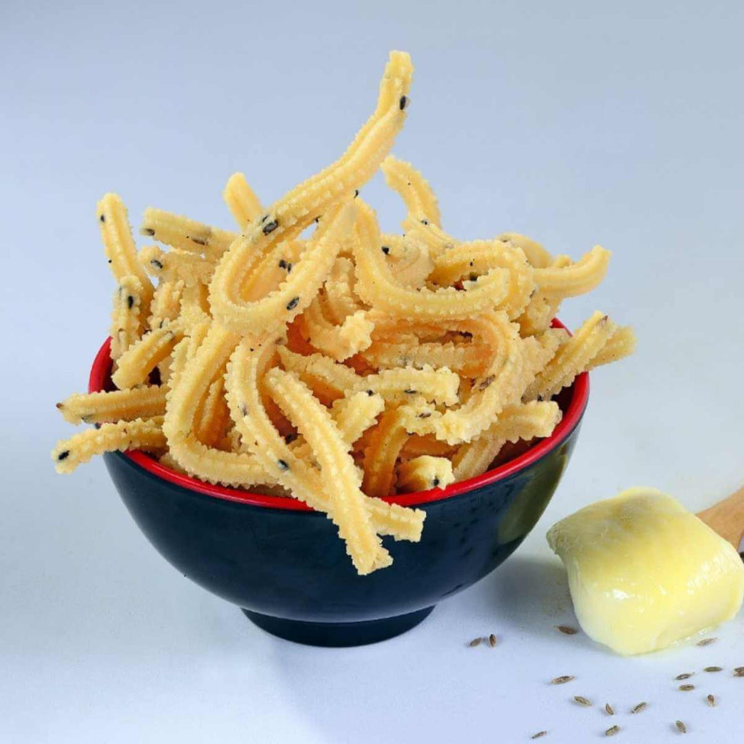 A bowl of Butter Murukku, a deep-fried snack, served with a side of butter.