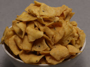 A bowl filled with crispy, golden-brown snack chips spiced with herbs and spices.