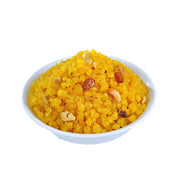 A bowl of Sweet Boondhi, which consists of yellow puffed rice cereal with peas and cashew nuts.
