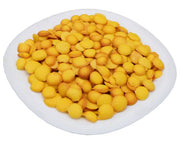 A plate of small, round, yellow mini biscuits arranged closely together.