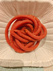 Red spiral candy on a textured white surface
